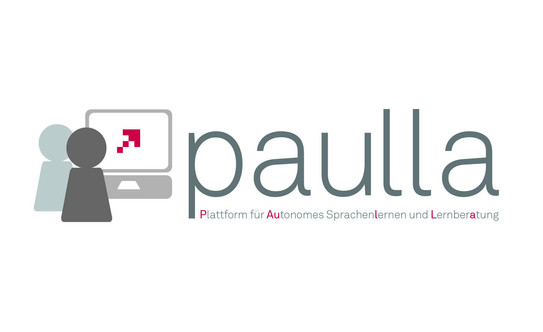 Logo with lettering "Paulla" and small figure in front of screen