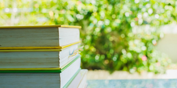 Books on table, tree in background