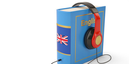 Set up book in blue with inscription English, headphones placed on the book