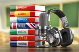 Textbooks foreign languages stacked with headphones next to them