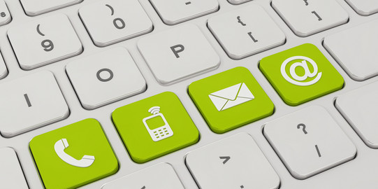 contact A white keyboard with four green keys. On the green keys are symbols like a telephone, a cell phone, an envelope and an „@“